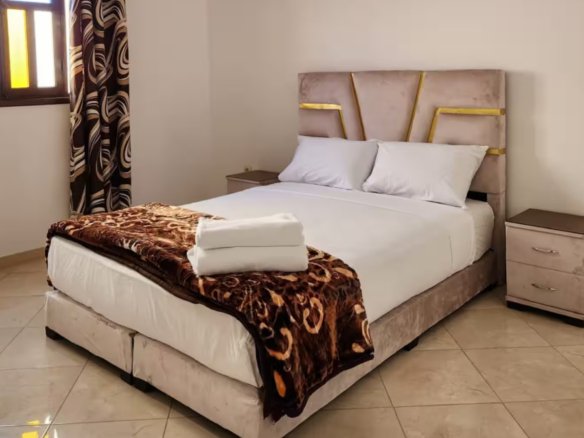 Cozy bedroom with soft lighting in a Kridari-managed apartment.