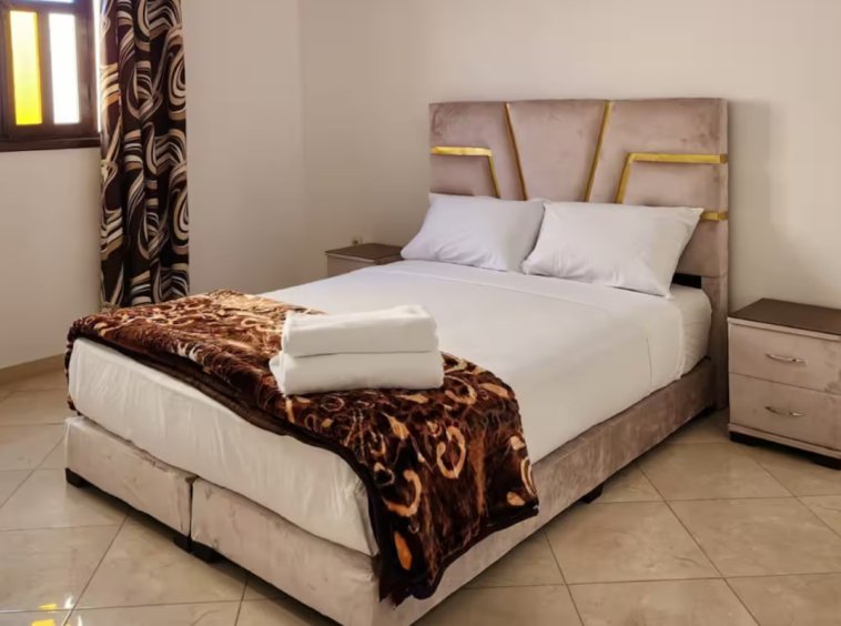Cozy bedroom with soft lighting in a Kridari-managed apartment.