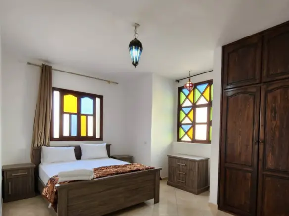 Couple relaxing in a Kridari rental’s cozy bedroom.