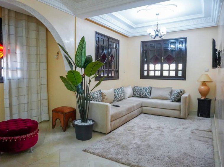 Inviting living room with a cozy sofa in a Kridari apartment for rent.