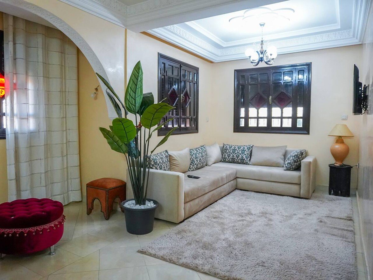 Inviting living room with a cozy sofa in a Kridari apartment for rent.