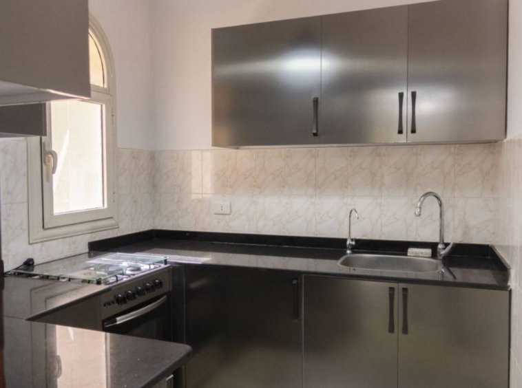 Elegant kitchen with custom cabinetry in a Kridari rental.