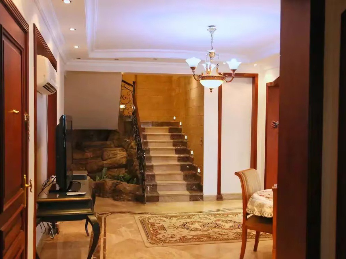 Warm living room with a fireplace in a Kridari apartment.