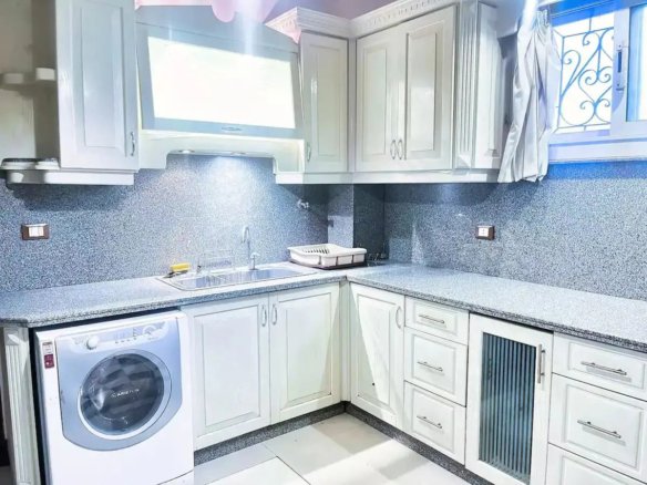 Elegant kitchen with custom cabinetry in a Kridari rental.