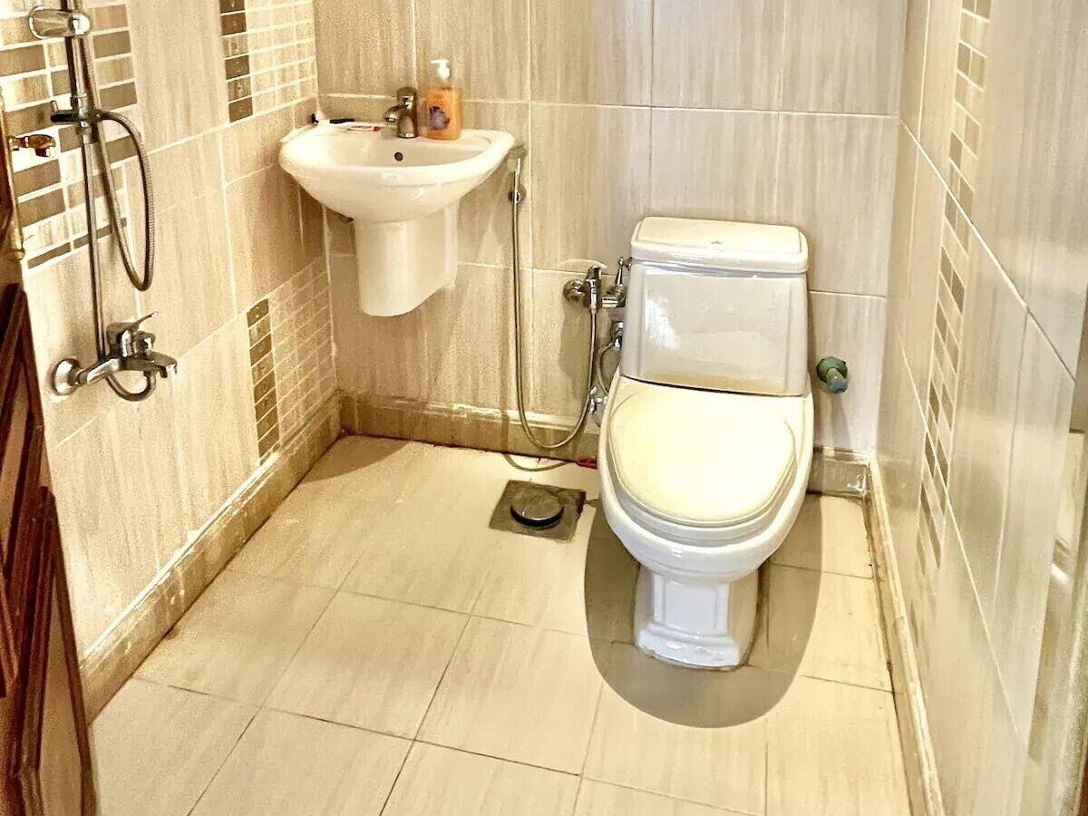 Stylish bathroom with tiled walls in a Kridari property.