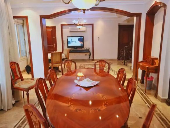 Warm living room with a fireplace in a Kridari apartment.
